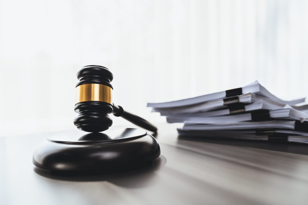 Black Wooden Gavel Hammer And Legal Document In Empty Law Firm O