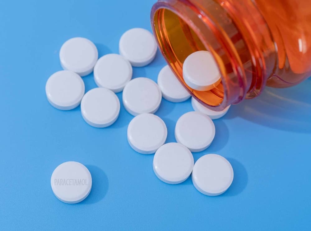 bottle with pills falling out