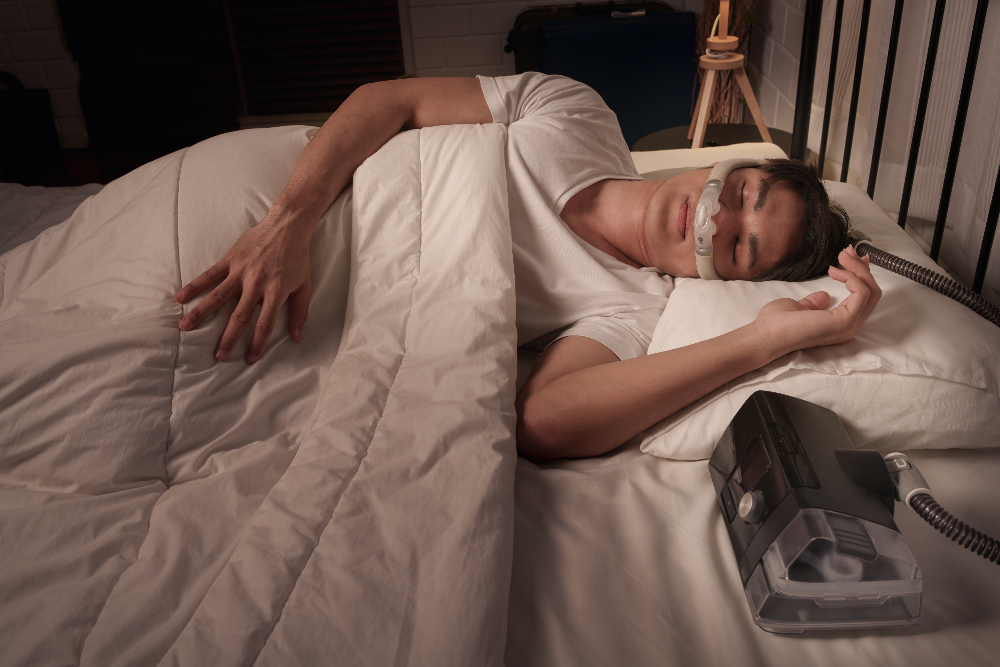 man using a CPAP machine for his sleep apnea