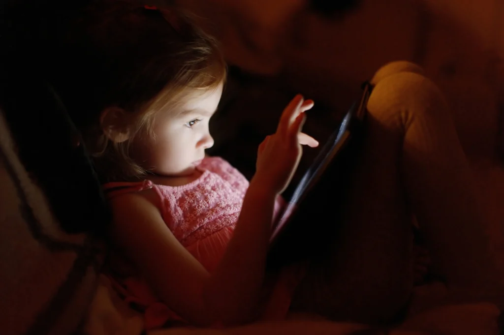 young girl playing game on tablet - Video Game Addiction Lawsuits - Lawsuit Legal News 