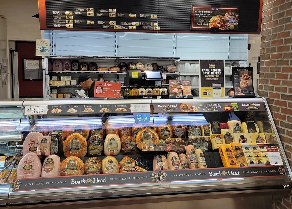 Boar's Head hams, cheeses, sausages at deli counter - LLN