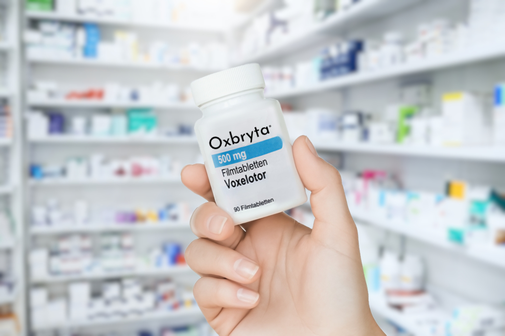 Oxbryta pill bottle in woman's hand at a pharmacy