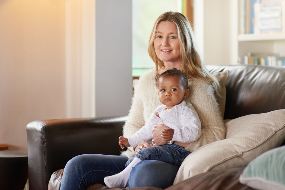 mother holding foster baby who has experienced mistreatment in the system