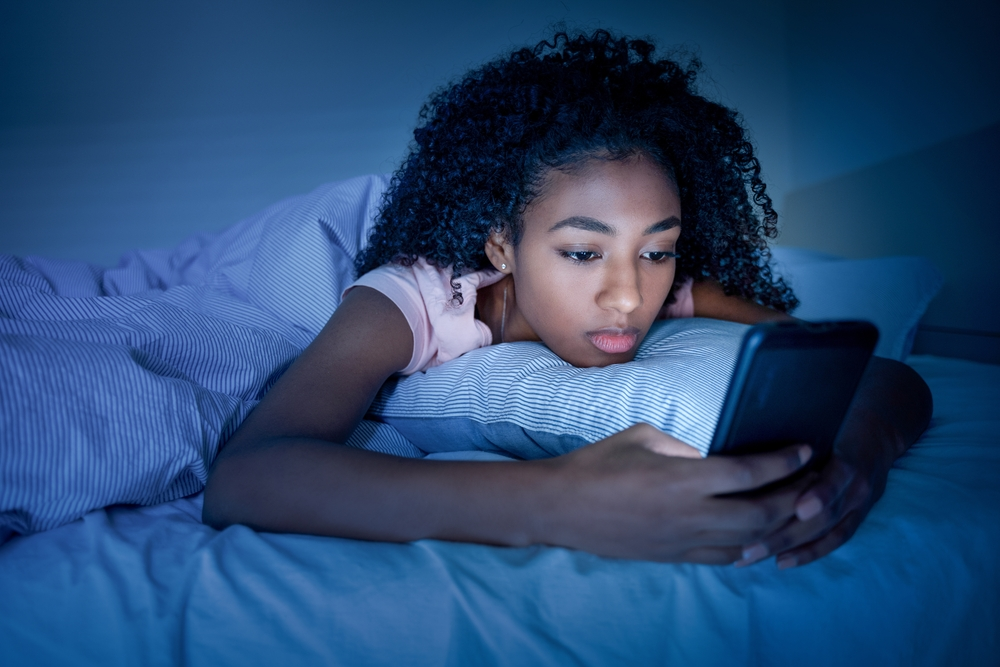 teen girl in foster home laying on bed feeling depressed