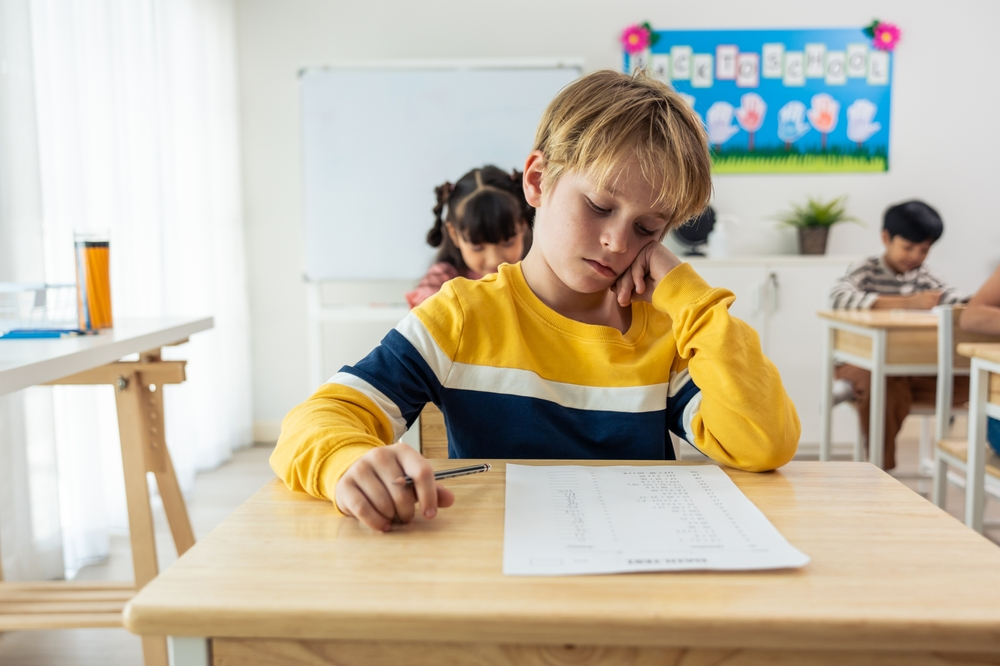 young boy struggles to concentrate at school because of abuse in his foster home
